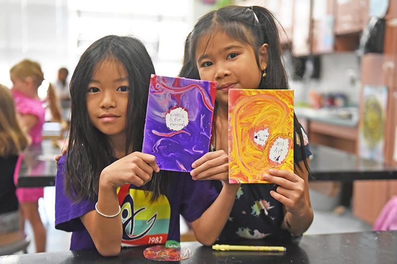 Two CFISD elementary students take a painting class at Camp Captivate, a specialty camp that includes STEAM classes.